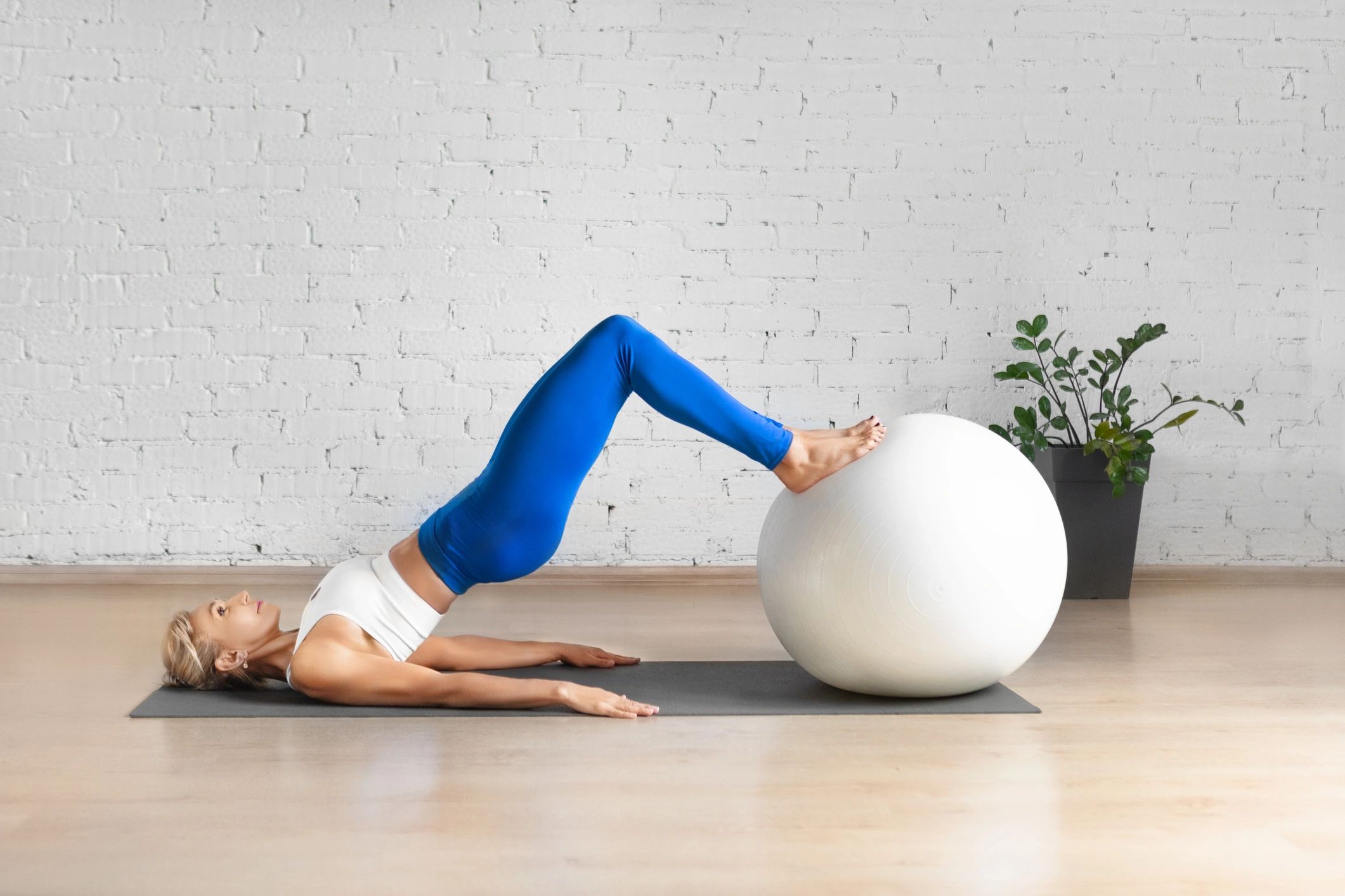 Woman exercising with a stability ball in a wellness studio
